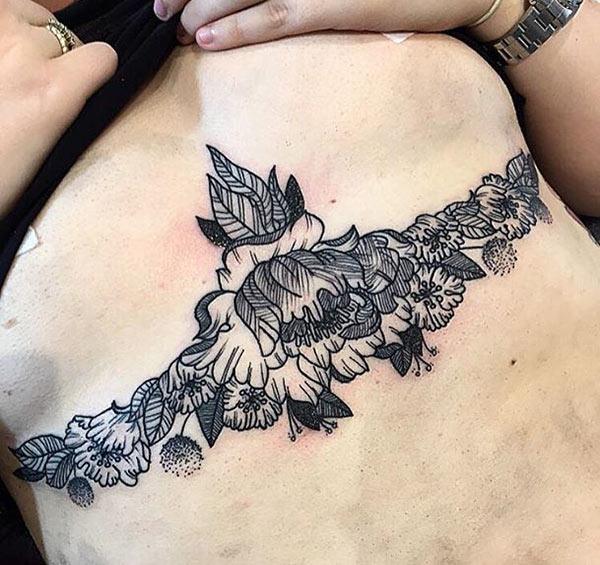 Sternum tattoofor Women with a black flower design make them look lovely