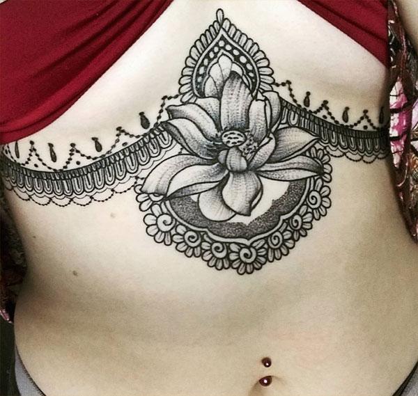 Sternum tattoo for Women with a blackink flower design makes them look captivating