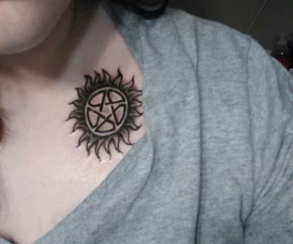 Supernatural tattoo on the upper chest brings a feminist and sexy look
