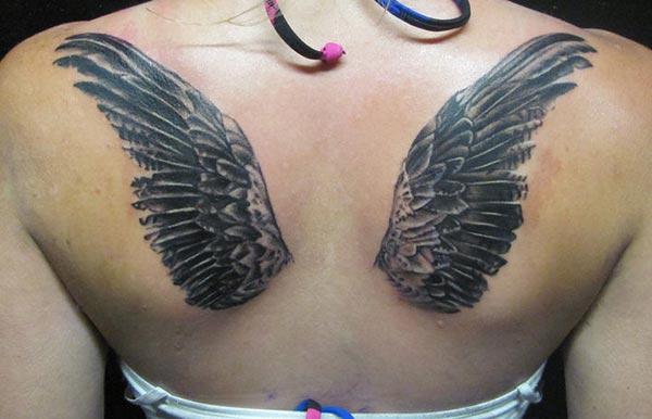 Wing tattoo with black ink design on the back brings a gorgeous look