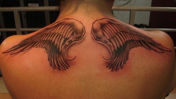 Wing tattoo with brown ink design on the back neck brings a gorgeous look