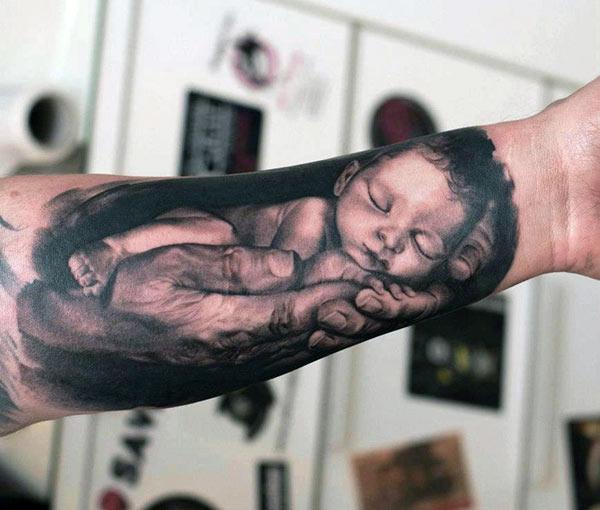 Baby tattoo on the lower arm makes a girl appear charming