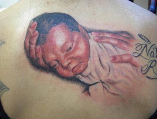Baby tattoo on the back abdomen make a lady look captivating 