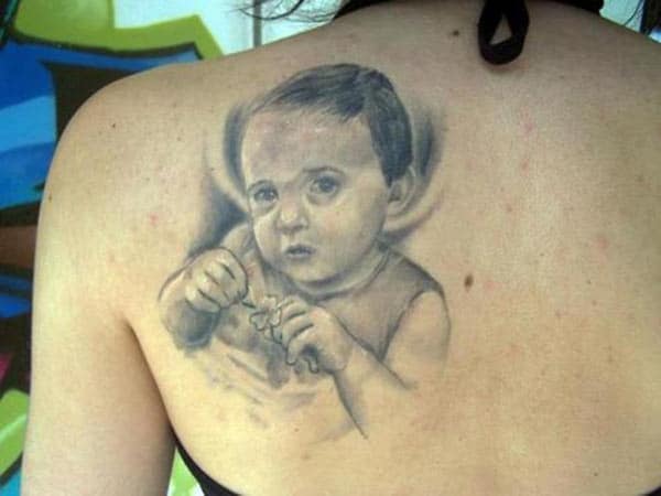 Baby tattoo on the back shoulder make a girl look elegant
