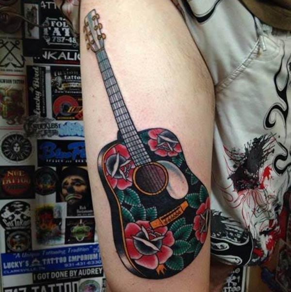 The Guitar Tattoo on the side thigh of a man make it look attractive 