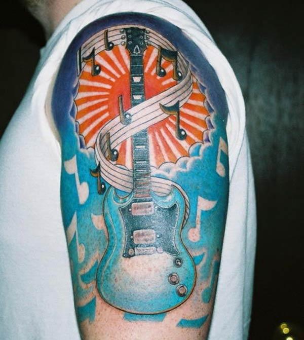 Guitar Tattoo on the left arm make a man have an august look