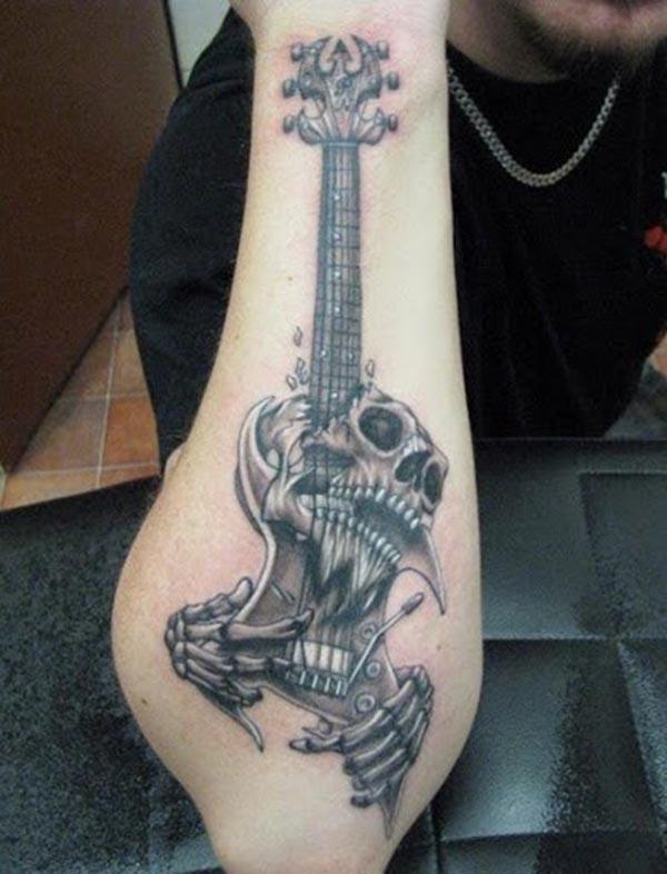 Guitar Tattoo on the lower arm make a man appear stunning