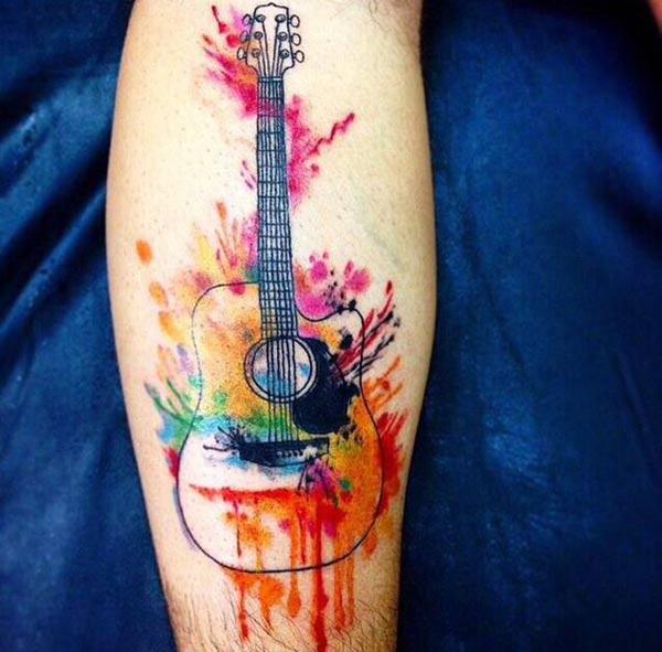 Guitar Tattoo for men with bright ink design makes a man look cute