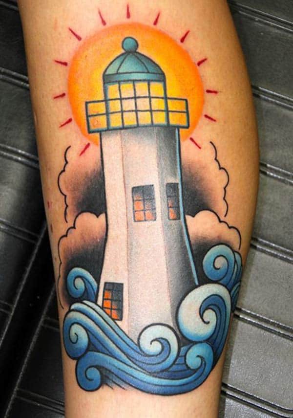 The brown, blue and yellow design ink of the Lighthouse Tattoo on the foot matches the skin color give a man a dapper look