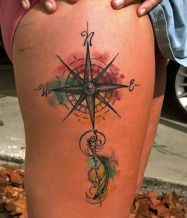 engaging watercolor compass tattoo on thigh for ladies