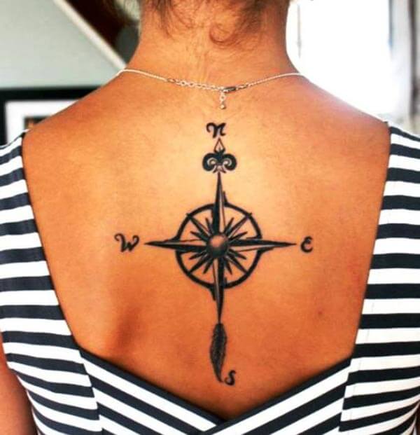 solid black star compass tattoo design for ladies on back