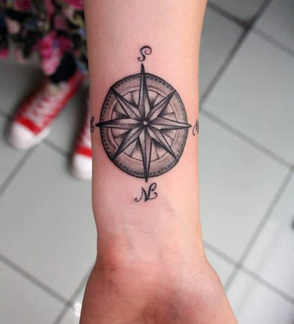 Cool black and grey compass tattoo design on wrist for Girls