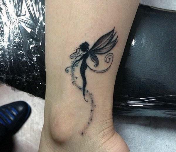 Ankle tattoo with a black ink design matches the skin color to make a girl look pretty 