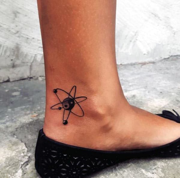 The Ankle tattoo with a dark ink design make a girl look admirable