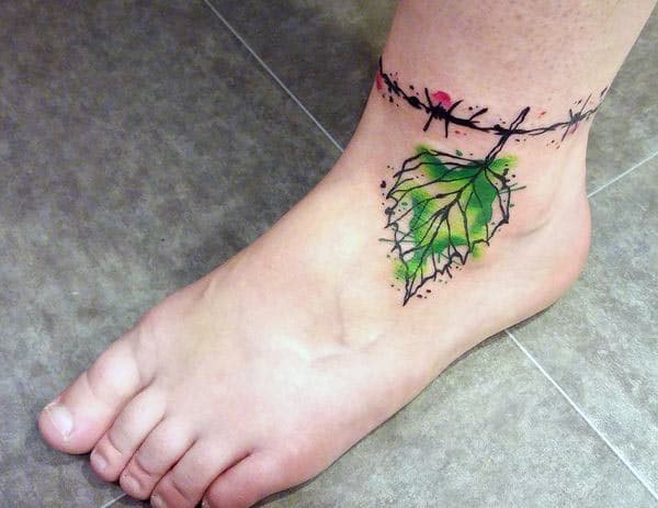 Ankle tattoo with a green leaf ink design make a girl look stylish