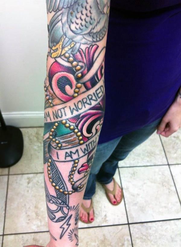 The Arm tattoo on the upper right arm with a colorful ink design make a girl look admirable 