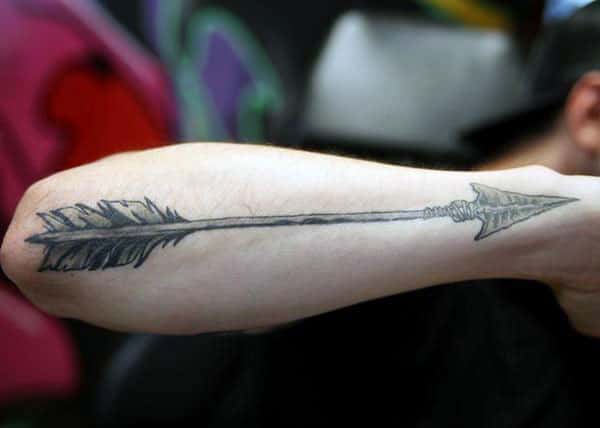 Arrow Tattoo on the lower arm makes a man have a hunky look