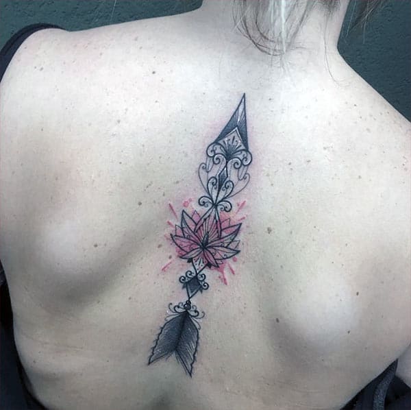 Arrow Tattoo on above the back with a black ink design brings the captivating look