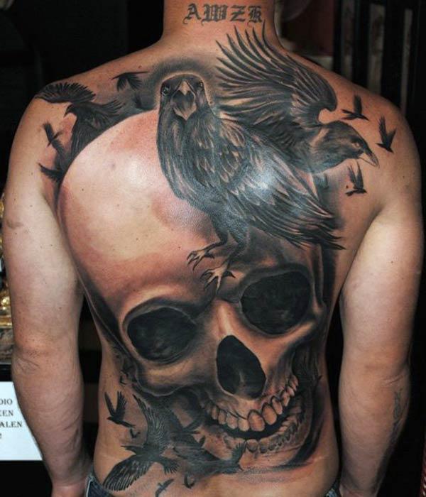 The Back Tattoo with a black ink design bird make a man have a fancy look