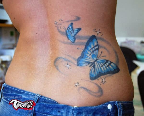 Butterfly tattoo on the back abdomen make a lady look captivating 