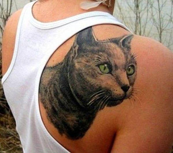 Cat tattoo on the back shoulder make a girl look stunning