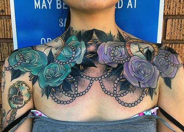Chest Tattoo with blue and purple ink design brings the feminist look