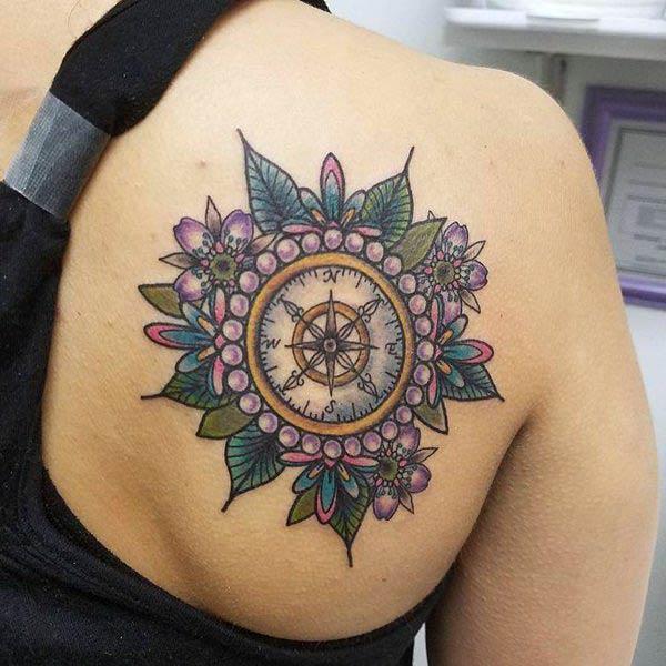 Compass tattoo for Women with a purple flower design ink; makes them look charming