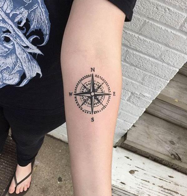 Compass tattoo on the lower arm makes a lady look captivating