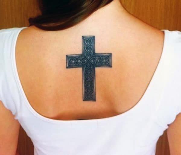 Cross tattoo at the back of girls gives a sexy look