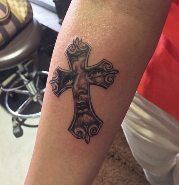 Front arm with a cross tattoo is cute for girls