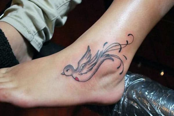 Dove Tattoo on the foot makes a girl look imposing