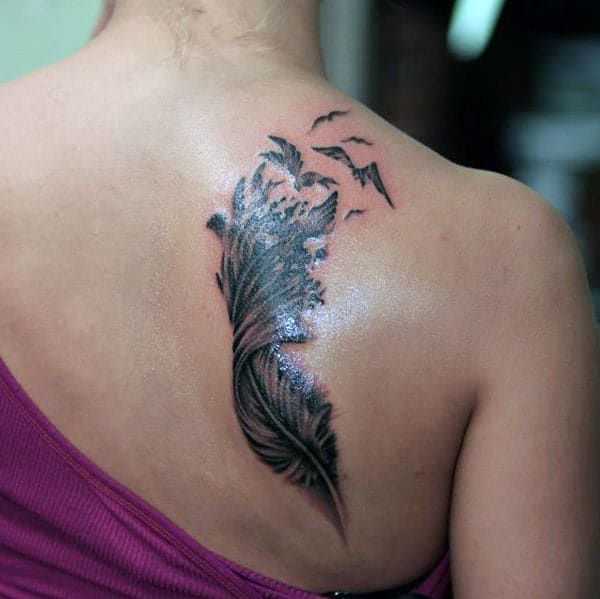 Feather tattoo on the back shoulder makes a girl alluring