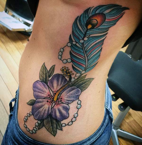 Feather tattoo with a purple ink flower design makes girls to appear gorgeous 