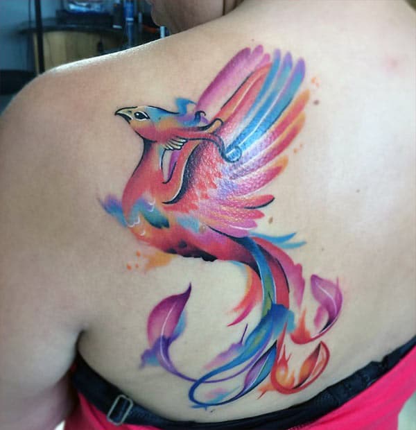 The Phoenix tattoo on the back shoulder with a pink ink design, make girls have splendid look