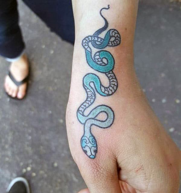 Snake tattoo on the wrist makes a girl look gorgeous