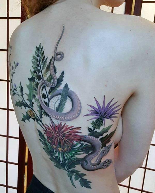 Snake tattoo on the lower back brings the elegant gaze