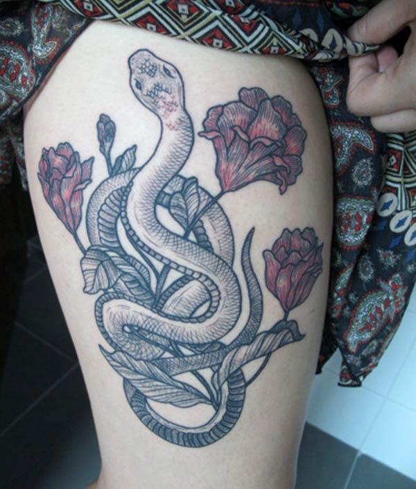 Snake Tattoo for the upper thigh brings their feminist look
