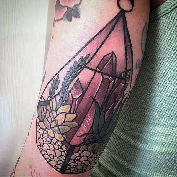 Geometric tattoo on the arm makes a woman look captivating