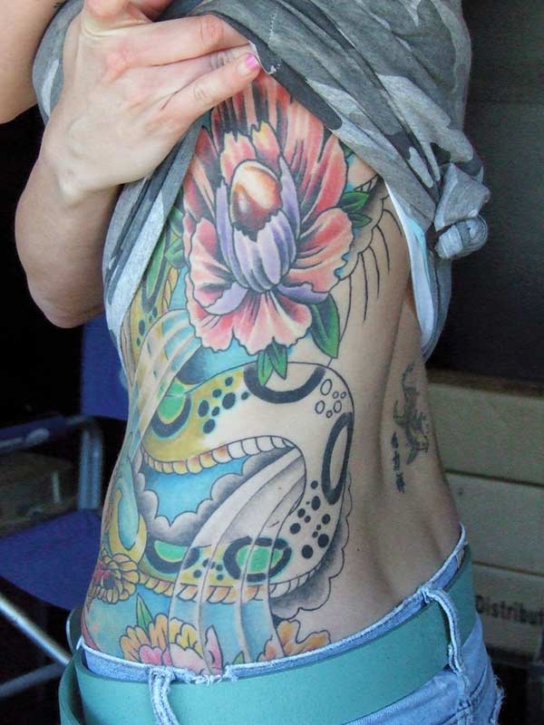 Girl Tattoo with a blue and pink ink flowers makes them look enchanting