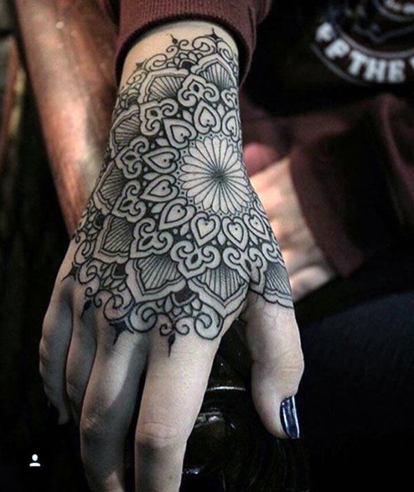 Hand tattoo with a black ink flower design makes them look captivating