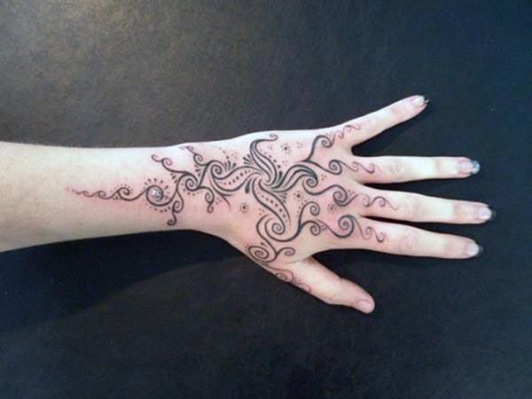 Hand tattoo with a black ink design makes a woman look captivating
