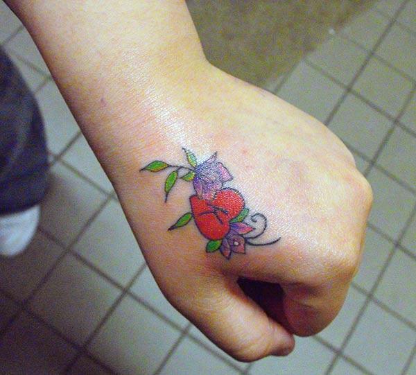 Hand tattoo with a pink flower ink design makes girls have magnificent look 