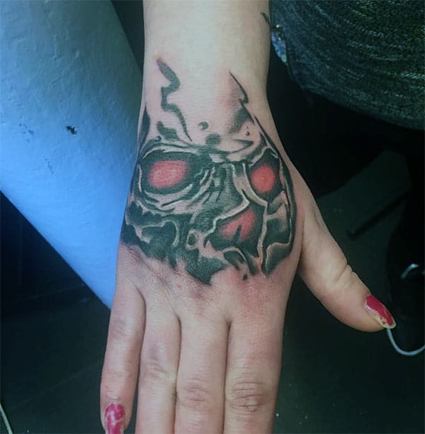 Hand tattoo with a black and red ink design makes a girl appear charming 