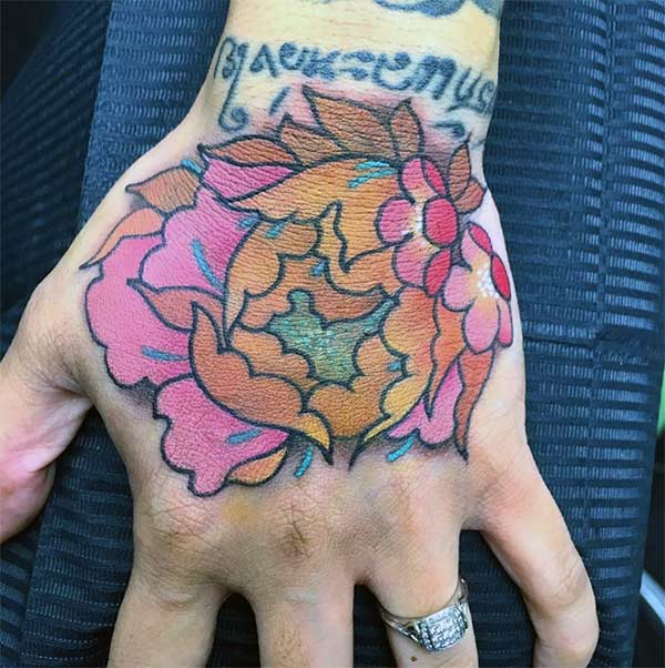 Hand tattoo with a pink flower design brings the astonishing look