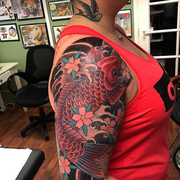 Koi Fish Tattoo for Women with a flower make them look sexy