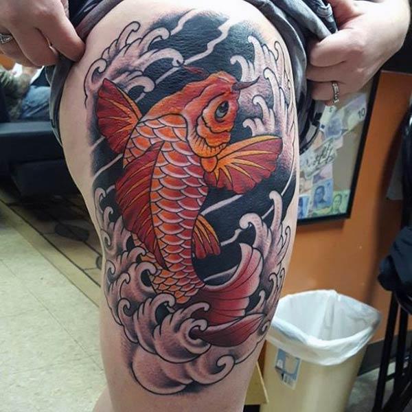 Koi Fish Tattoo for Women on the upper thigh make them look classy