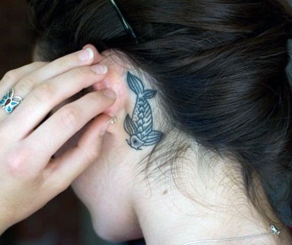 Koi Fish Tattoo for Women with a black ink brings their beguiling appearance
