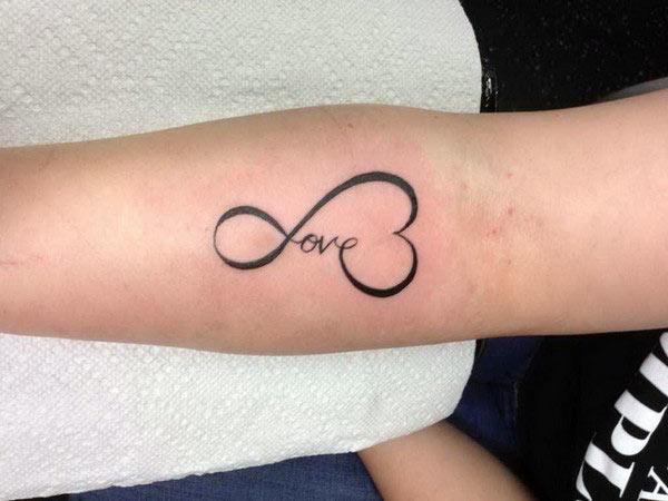 Love tattoo on the lower arm brings the astonishing look