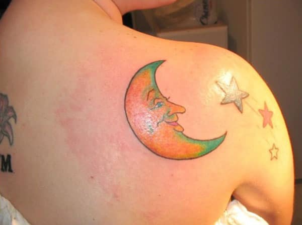 Moon tattoo with an orange ink design make woman look decorative