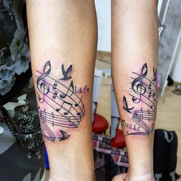 The Music Tattoo with a dark ink design make a girl look admirable